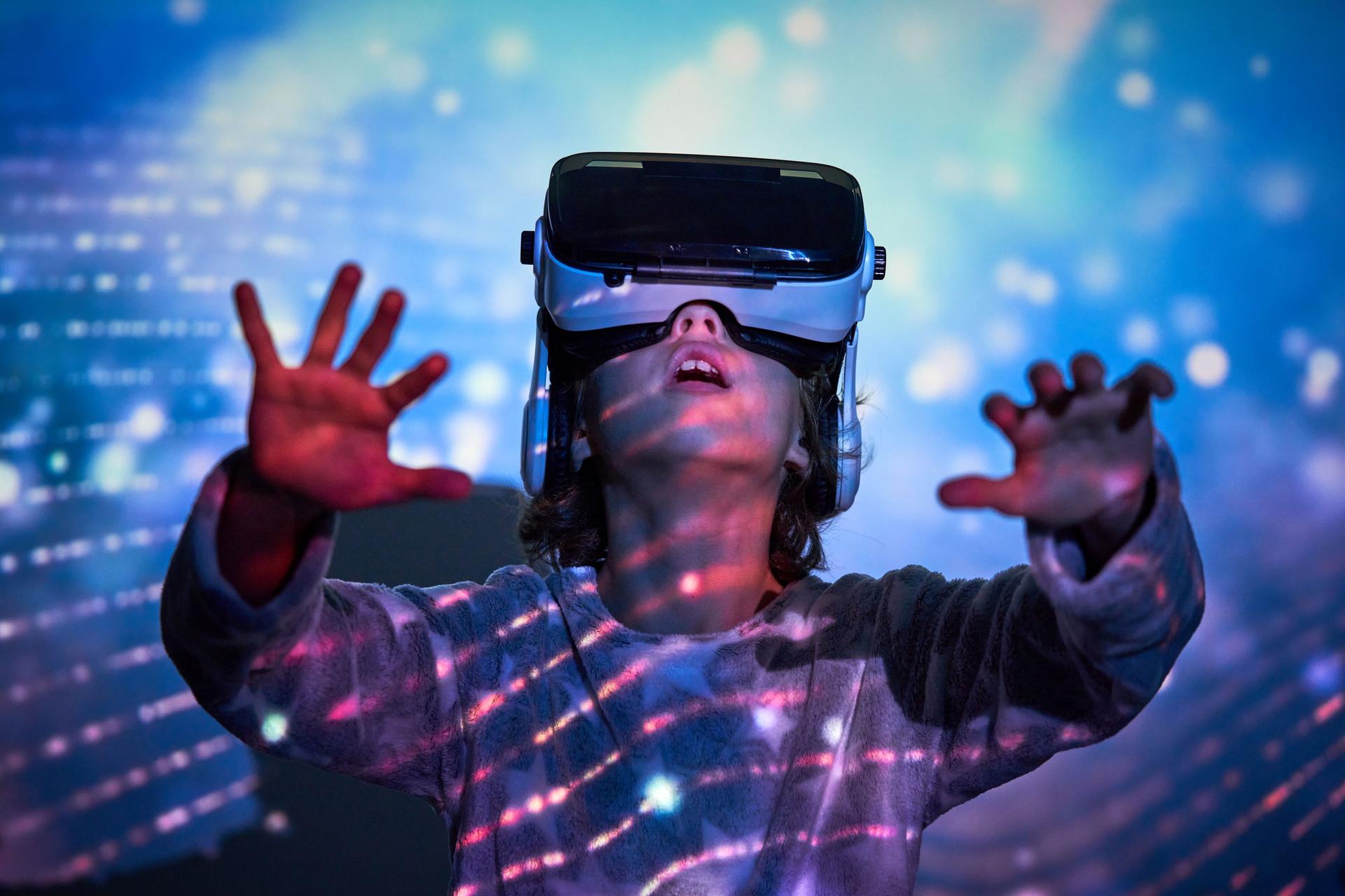 astonished boy wearing VR headset